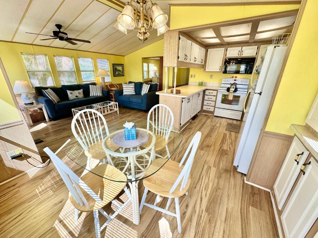 a kitchen and living room with a table and chairs at Beachfront Bliss N1026 in Jensen Beach