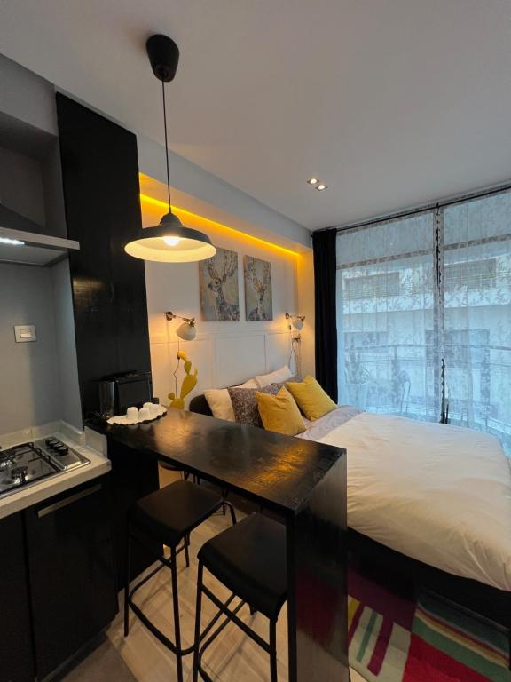 a bedroom with a bed and a desk and a kitchen at Stay In GAUTHIER studio s in Casablanca