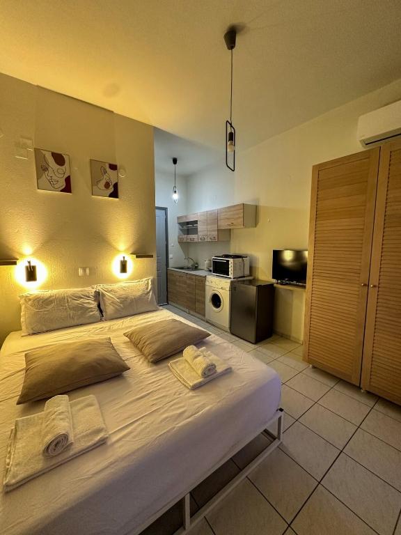 a bedroom with a large bed with towels on it at Dolphin Studio in Stalida