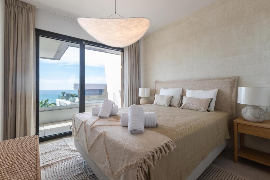 a bedroom with a bed with a view of the ocean at Casa El EDEN 39 in Mijas