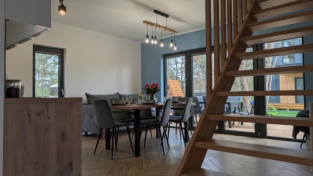 una cucina e una sala da pranzo con tavolo e sedie di Sosnowy Raj Borsk a Borsk