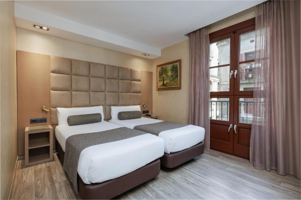 Postel nebo postele na pokoji v ubytování Hotel Suizo