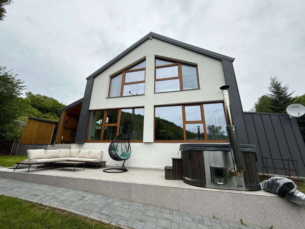 a house with a tv in front of it at Nessa Chalet in Moara de Pădure