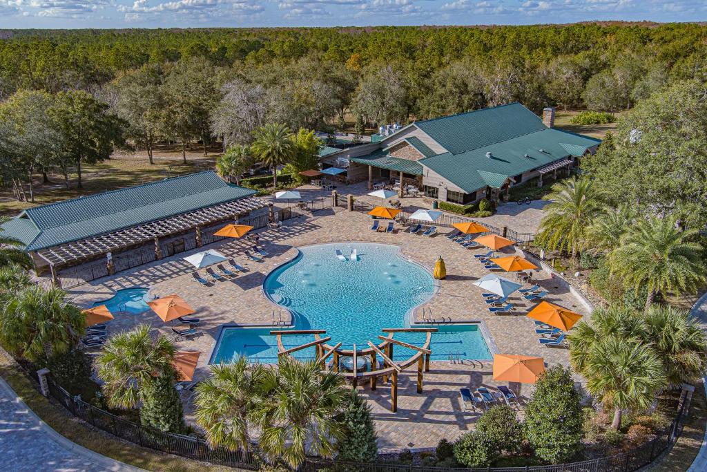 an aerial view of a resort with a pool and umbrellas at Black Prong Resort in Bronson