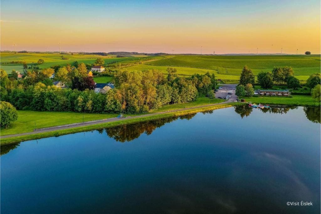 an aerial view of a lake at sunset at Anatura Luxembourg in Weiswampach