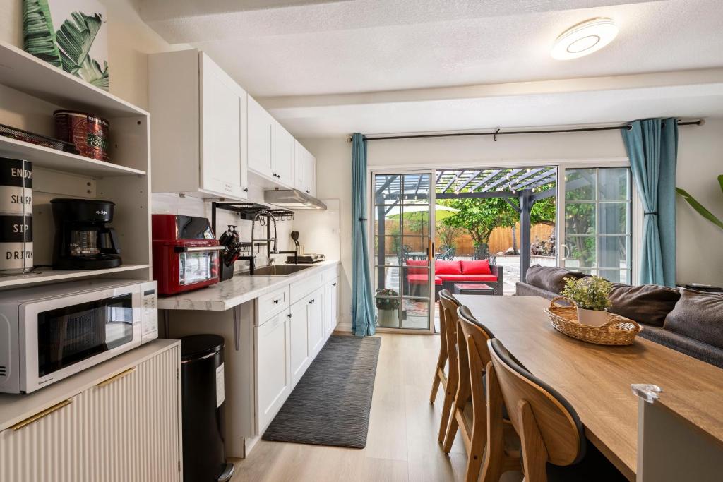 a kitchen and dining room with a table and a couch at 100% Private, KingBed- SouthCoast/Newport/Disney in Costa Mesa