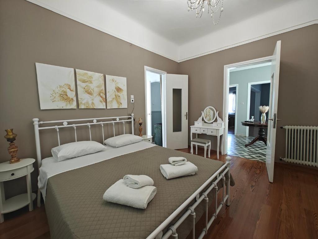 une chambre avec un grand lit avec deux serviettes dessus dans l'établissement Stefani retro luxury apartments, à Chalcis