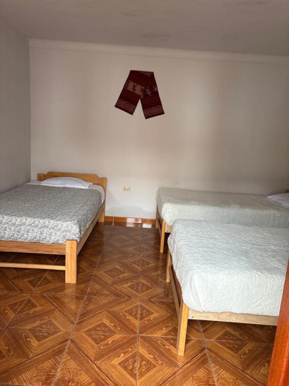 Postel nebo postele na pokoji v ubytování hostel arcoiris urubamba