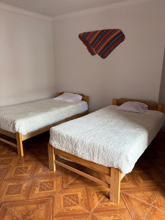 Postel nebo postele na pokoji v ubytování hostel arcoiris urubamba