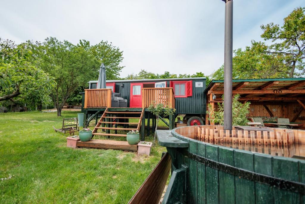 a fire truck parked in a yard with a fence at Naphegy Kuckó in Écs