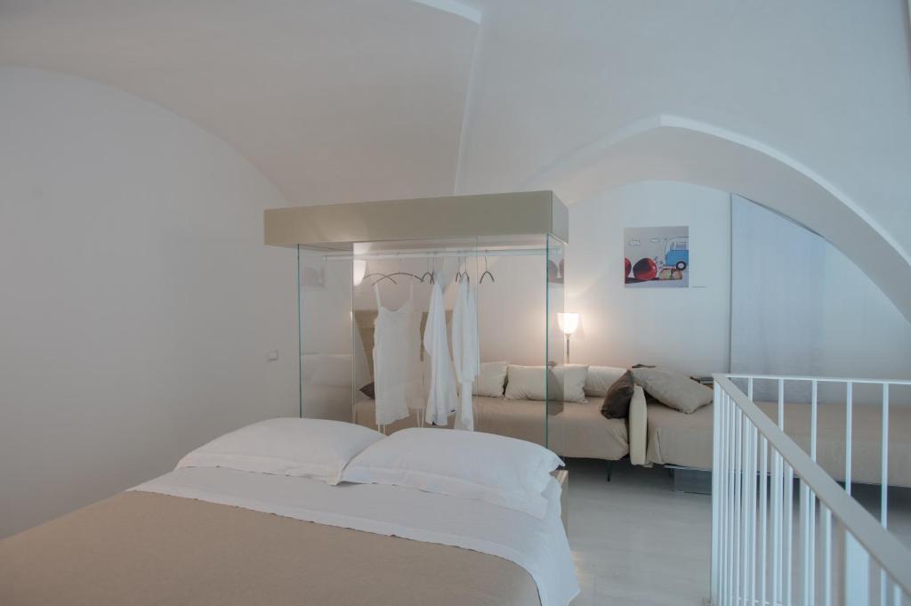 Postel nebo postele na pokoji v ubytování Corte Campanile Boutique B&B