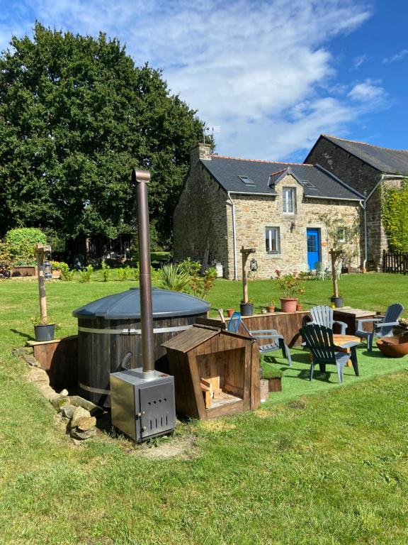 un barbecue all'aperto nel cortile di una casa di Pinabre Rose Cottage a Plouguenast Langast
