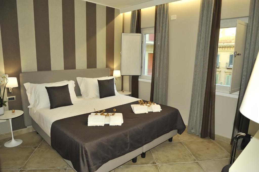 Posteľ alebo postele v izbe v ubytovaní ETNEA 454 Catania Luxury Rooms