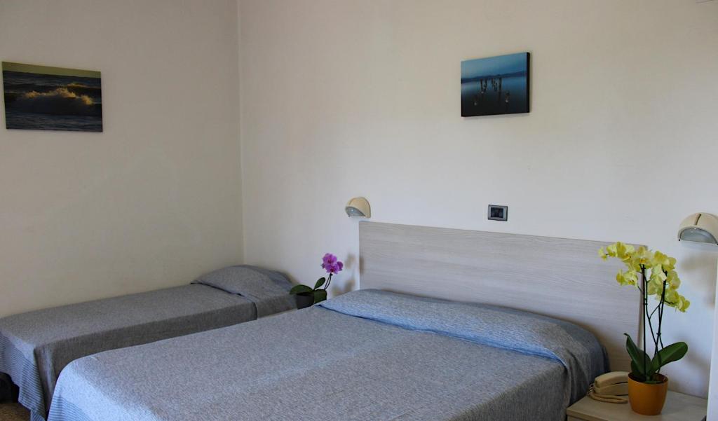Postel nebo postele na pokoji v ubytování Hotel Puccinelli