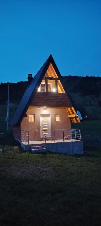 a large house with a lit up roof at night at Planinski san in Žabljak