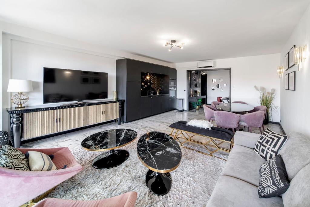 - un salon avec un canapé, des tables et une télévision dans l'établissement -CLR- Charming 3-Bedroom Apartment in the Heart of Cannes, à Cannes