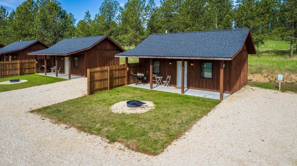 a cabin with a fire pit in the yard at Gold Valley Camp Cabin 5 in Custer