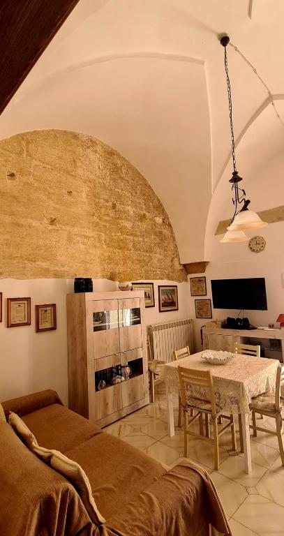 a living room with a table and a tv at Via Cufra 46 in Botrugno