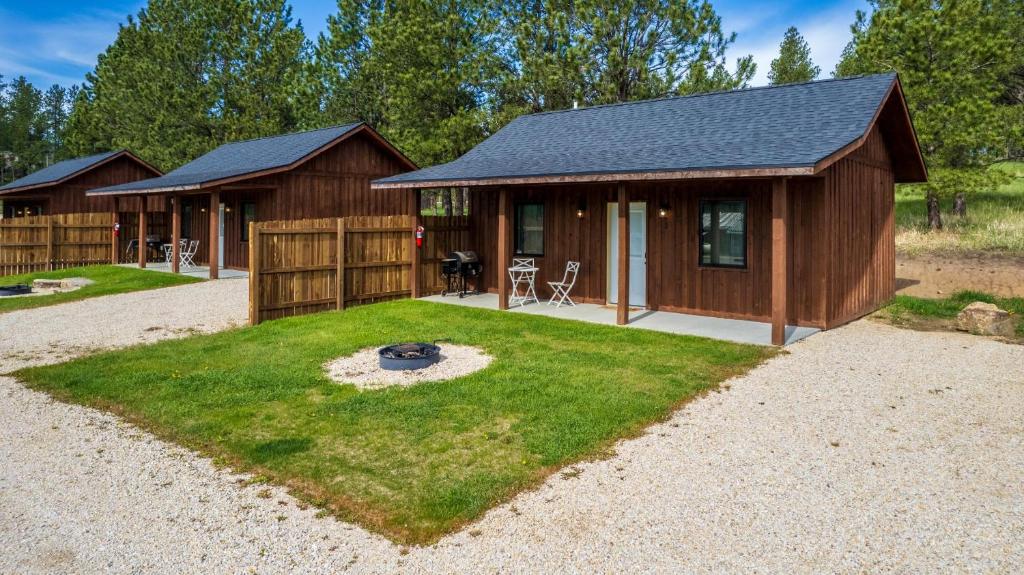 a small cabin with a grass yard in front of it at Gold Valley Camp Cabin 3 in Custer