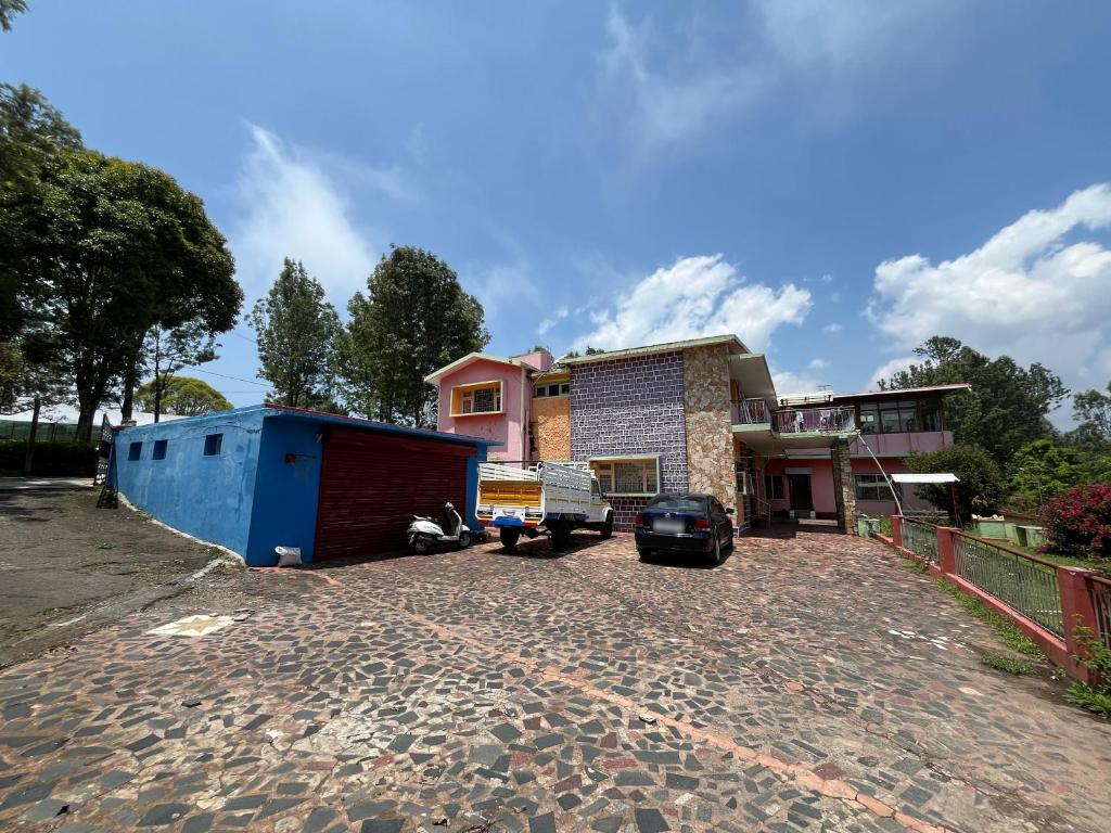 a house with a truck parked in a driveway at Aarroh villa in Coonoor