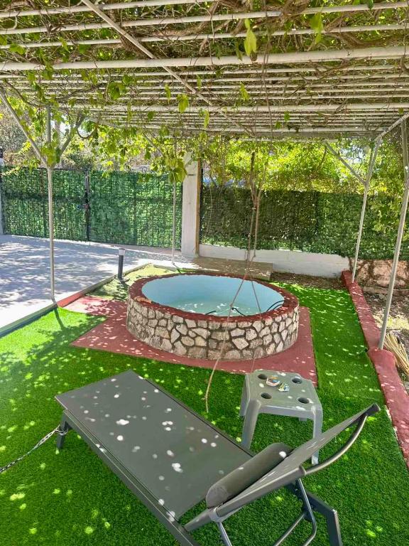 a patio with a pool and a swing and a chair at Evas Home in Argostoli