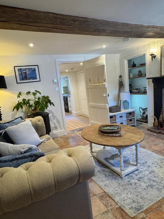 a living room with a couch and a table at 5 chapel lane Wymondham Norfolk in Wymondham
