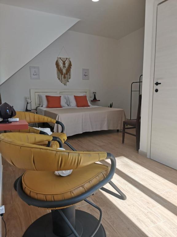 a room with a bed and a table and chairs at Casa Camelia - Elegant Palace with Terrace - Conversano in Conversano