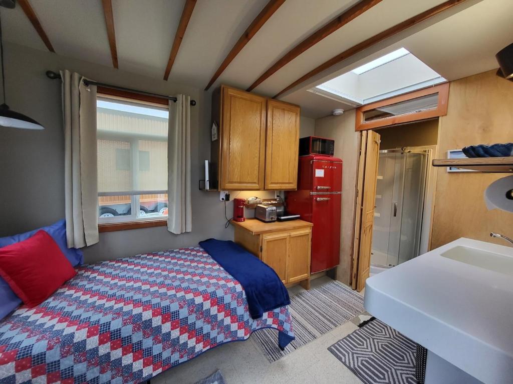 a small bedroom with a bed and a red refrigerator at Caravan Across The Street From The Beach in Blaine