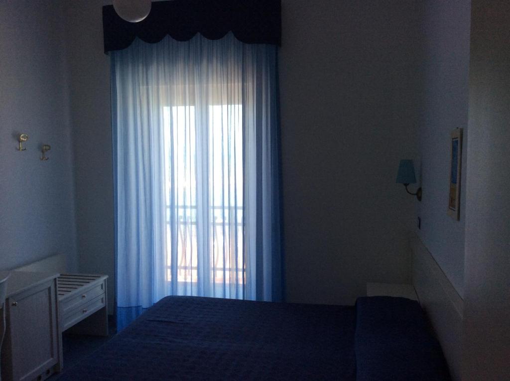 Postel nebo postele na pokoji v ubytování Hotel Elisa - Spiaggia Privata Inclusa