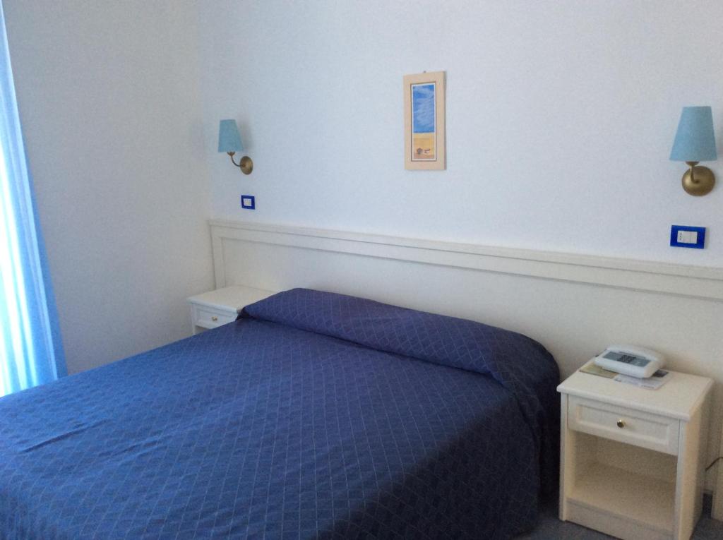 Postel nebo postele na pokoji v ubytování Hotel Elisa - Spiaggia Privata Inclusa
