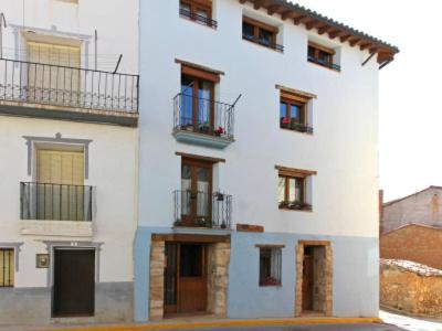 a white building with windows and balconies on it at Casa Chaparrete in Deza