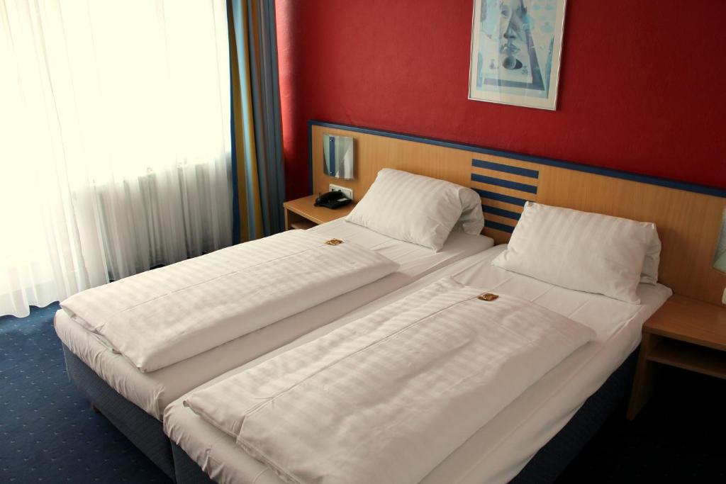 Postel nebo postele na pokoji v ubytování NP Hotel Wallis