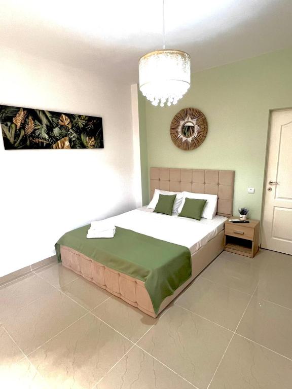 a bedroom with a large bed and a chandelier at Vila Sedef Costinești in Costinesti