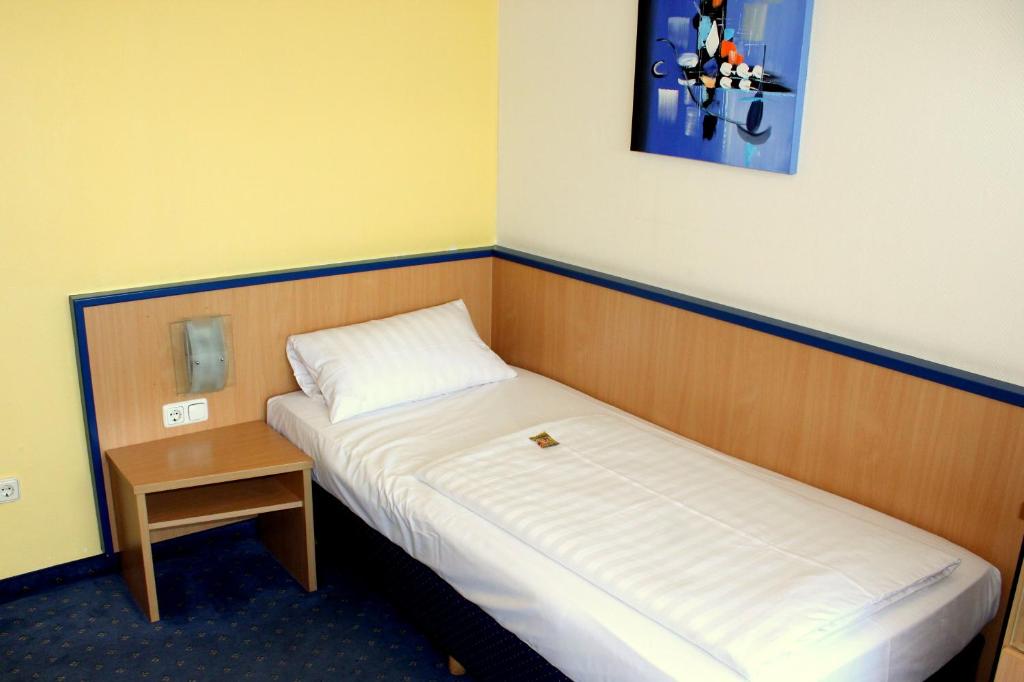 Postel nebo postele na pokoji v ubytování NP Hotel Wallis