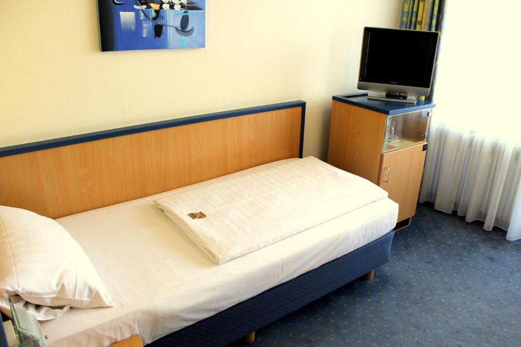 Postel nebo postele na pokoji v ubytování NP Hotel Wallis