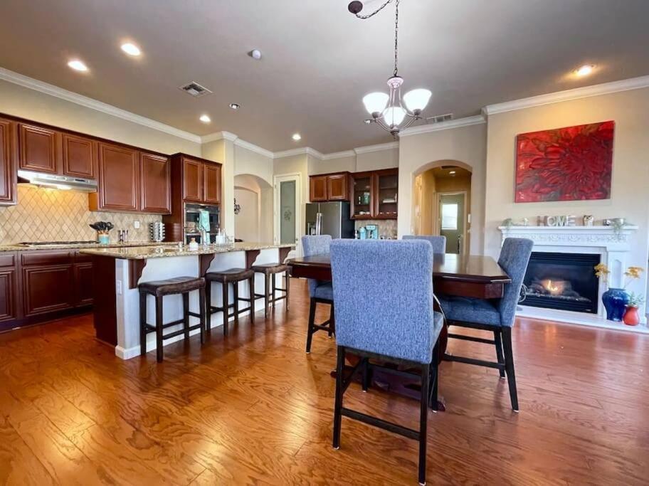 a kitchen with a table and chairs and a fireplace at One Story Pet & Family Friendly Fireplace in West Sacramento
