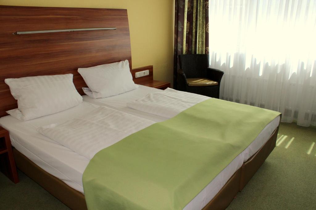 Postel nebo postele na pokoji v ubytování NP Hotel Wallis