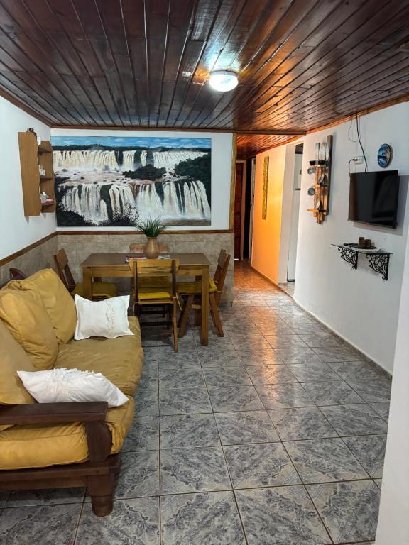 a living room with a couch and a table at Alojamiento Santino, en Cataratas del Iguazu in Puerto Iguazú