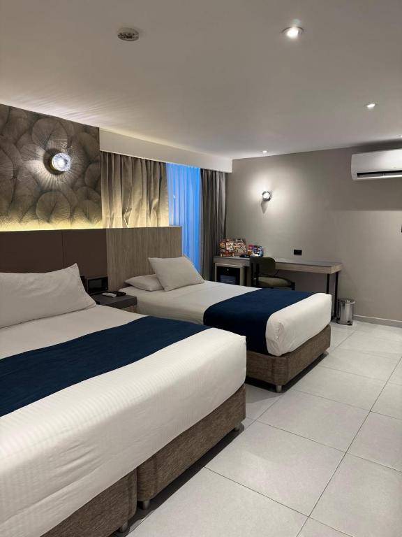Postel nebo postele na pokoji v ubytování Zi One Luxury Hotel