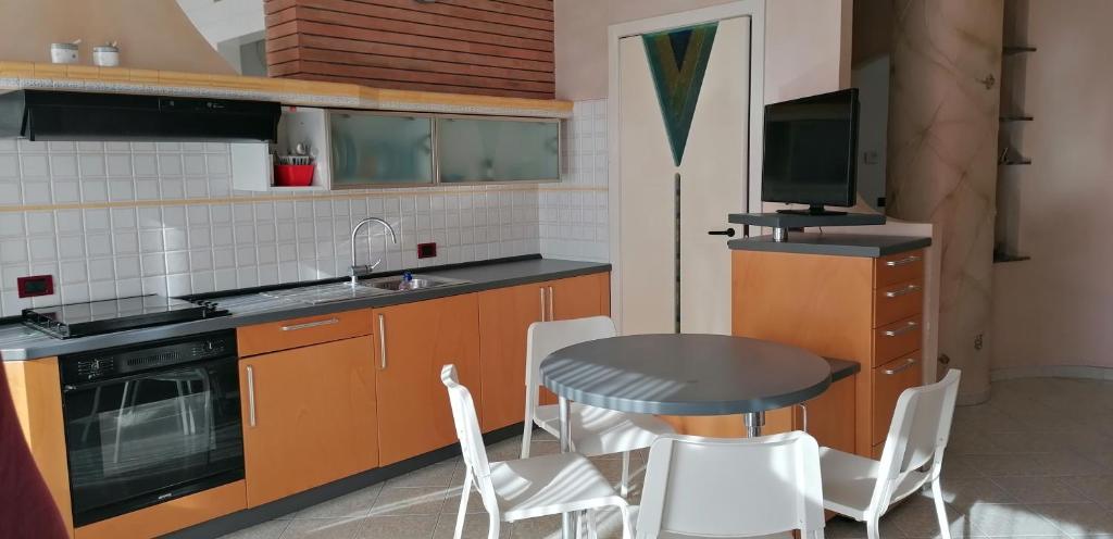 a kitchen with a table and chairs and a television at Casa Diamante con garage privato gratuito nella struttura in Termoli