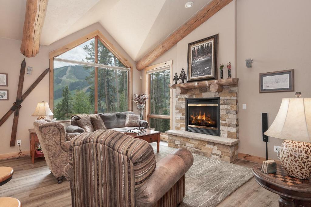 a living room with a couch and a fireplace at Lakota Lookout private hot tub in Winter Park