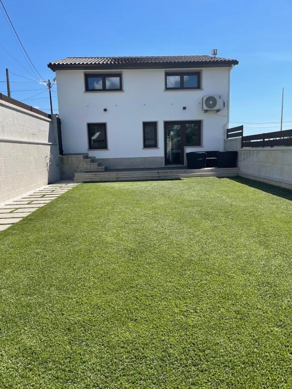 a house with a large lawn in front of it at Casa Galbán in Vilagarcia de Arousa
