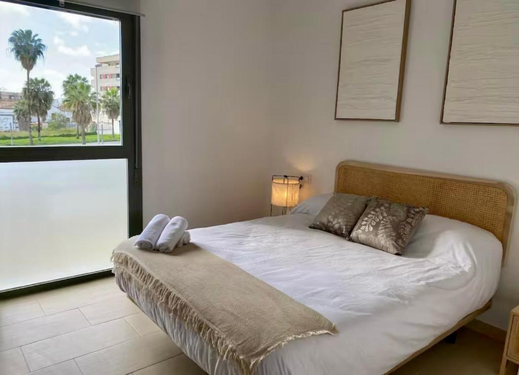 a bedroom with a bed with a phone on it at Refugio del Atlántico in El Puerto de Santa María