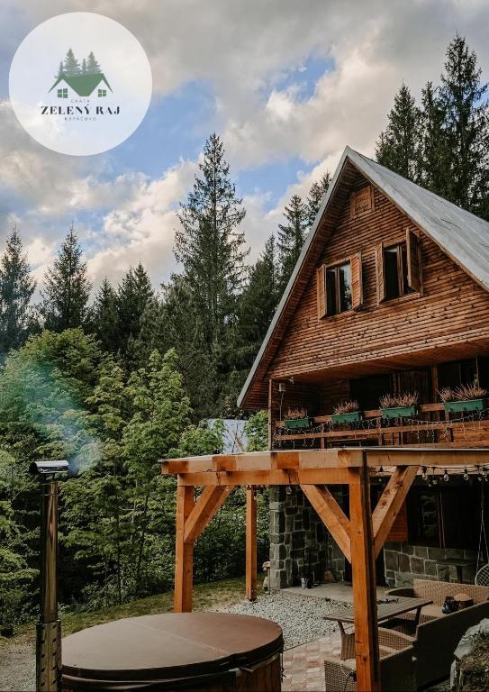 a log cabin with a grill in front of it at Chata Zelený raj in Horná Lehota
