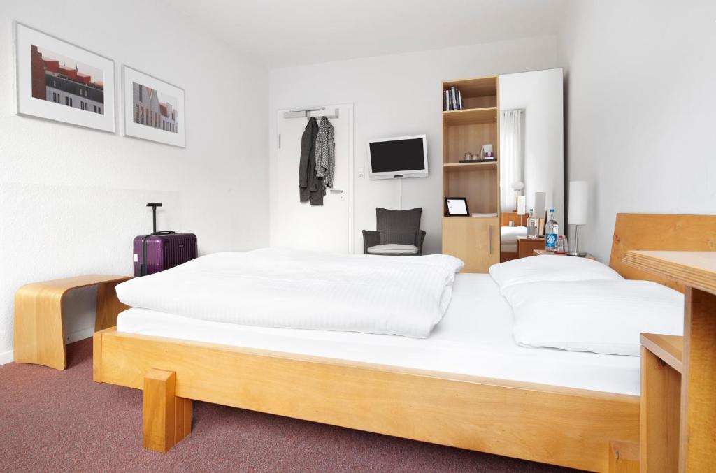 Postel nebo postele na pokoji v ubytování Hotel an der Marienkirche