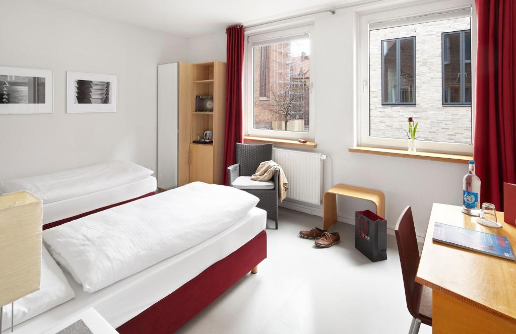 Postel nebo postele na pokoji v ubytování Hotel an der Marienkirche