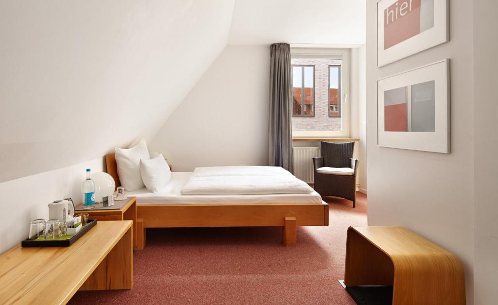 Postel nebo postele na pokoji v ubytování Hotel an der Marienkirche