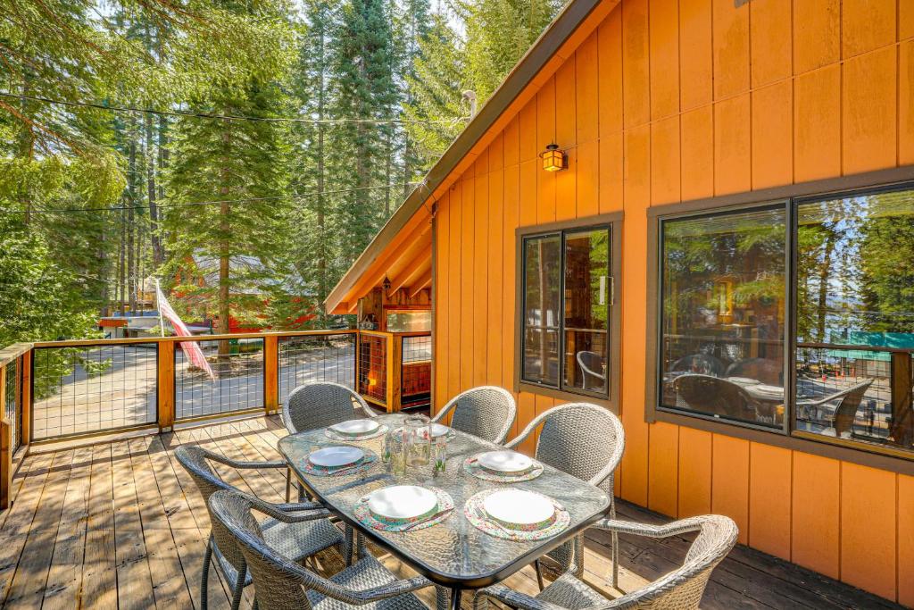a patio with a table and chairs on a deck at Walk to Lake Almanor Prattville Cabin with 2 Decks! in Canyondam