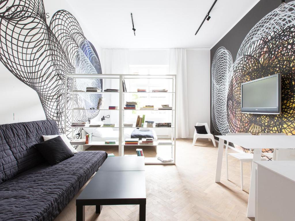 a living room with a couch and a tv at Boom Apartments in Krakow