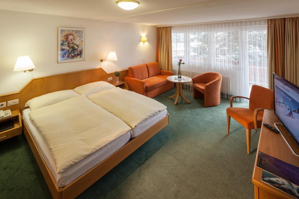 Postel nebo postele na pokoji v ubytování Hotel Cheminee
